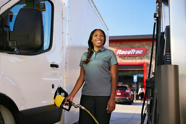 Fleet driver pumping gas in front of RaceTrac gas station