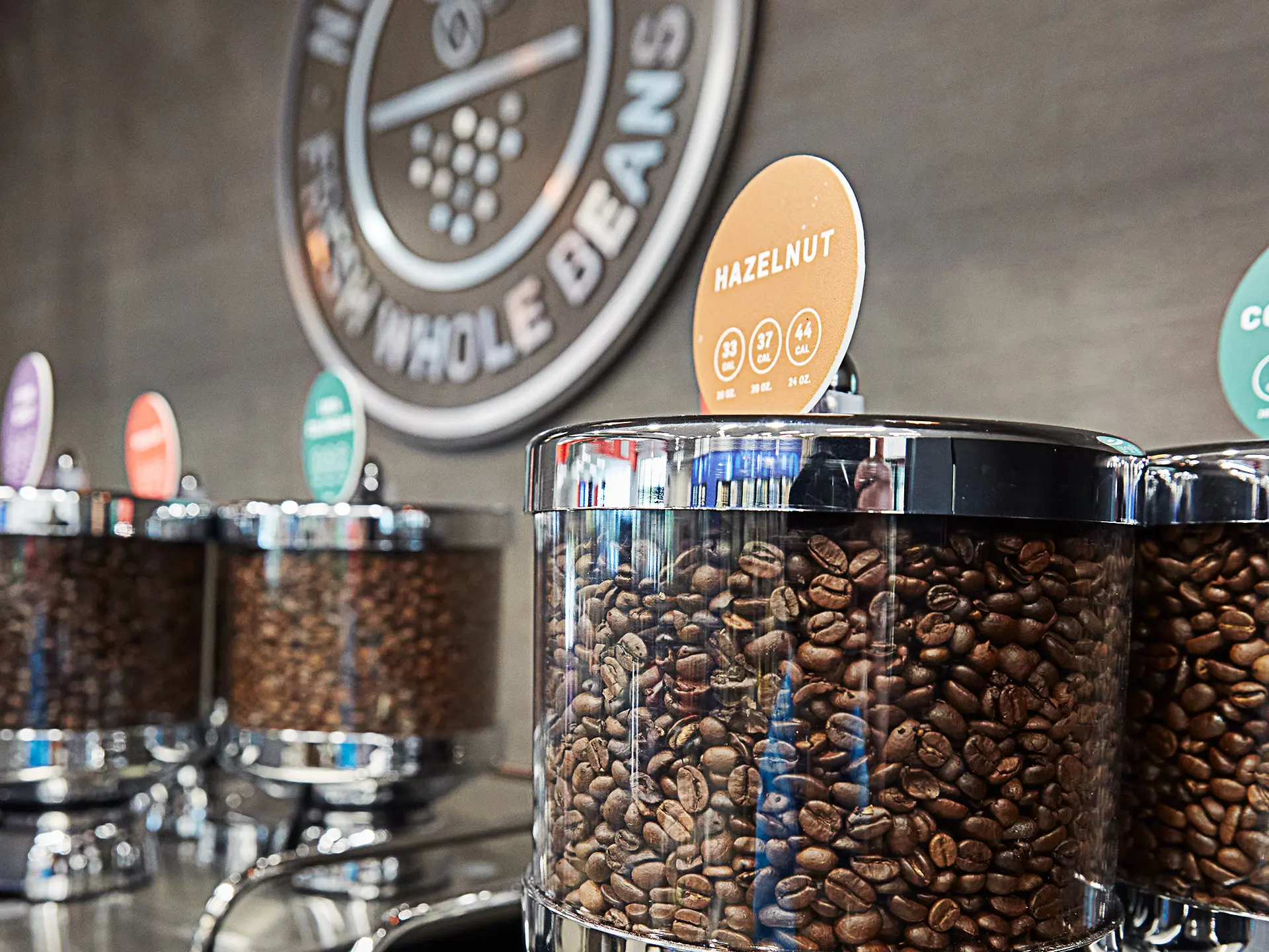 Hazelnut coffee beans above coffee machine