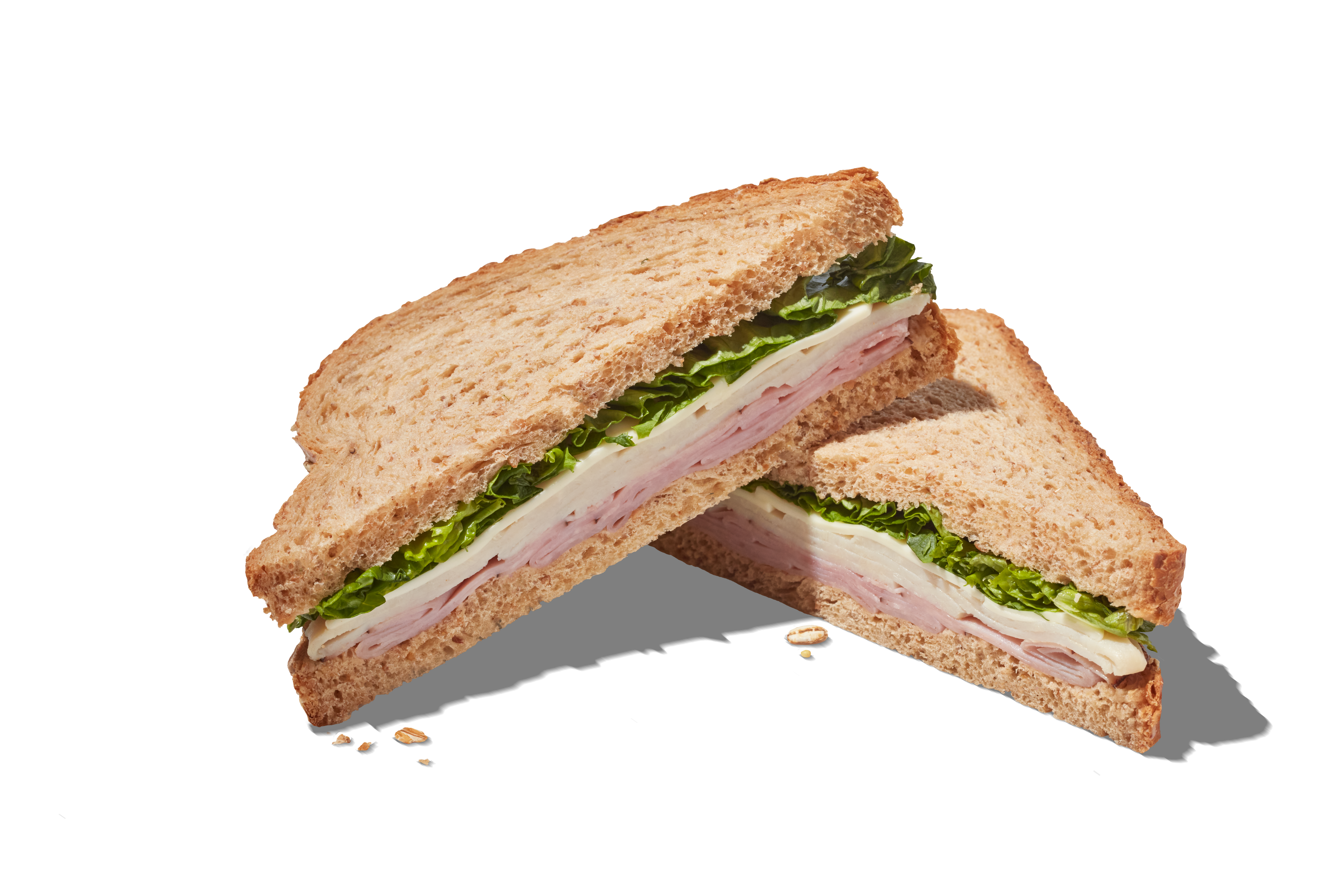 Triangle cut turkey, cheese, and lettuce sandwich.