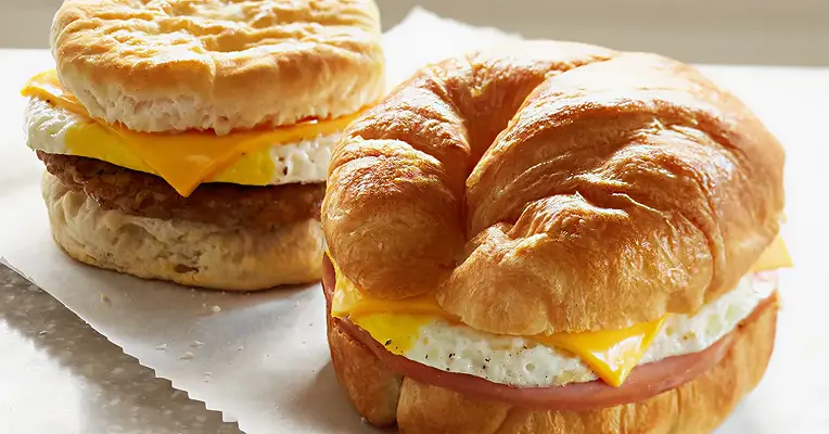 egg, sausage, and cheese biscuit and a ham, egg, and cheese croissant.