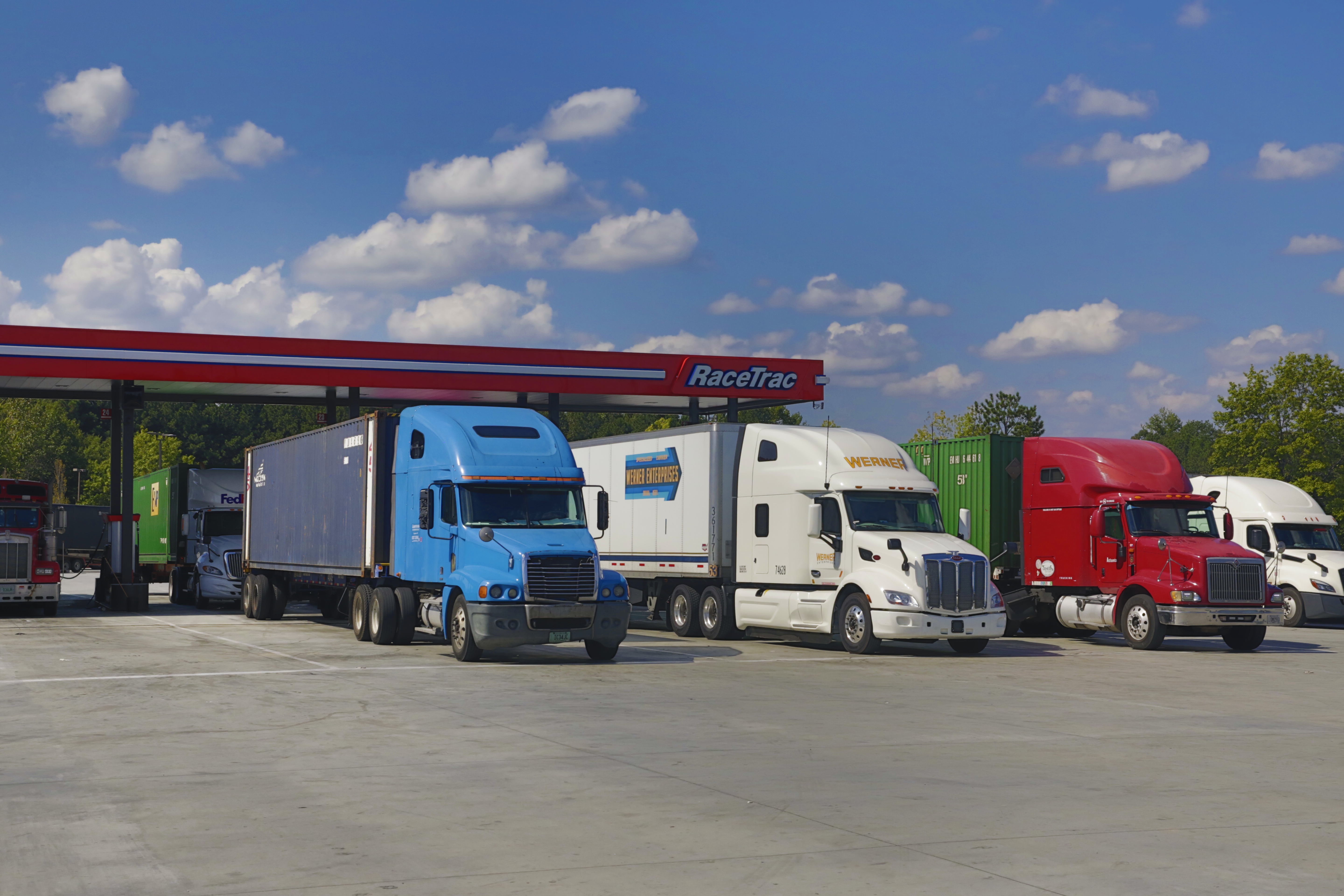 Semi trucks parked at a RaceTrac gas station.